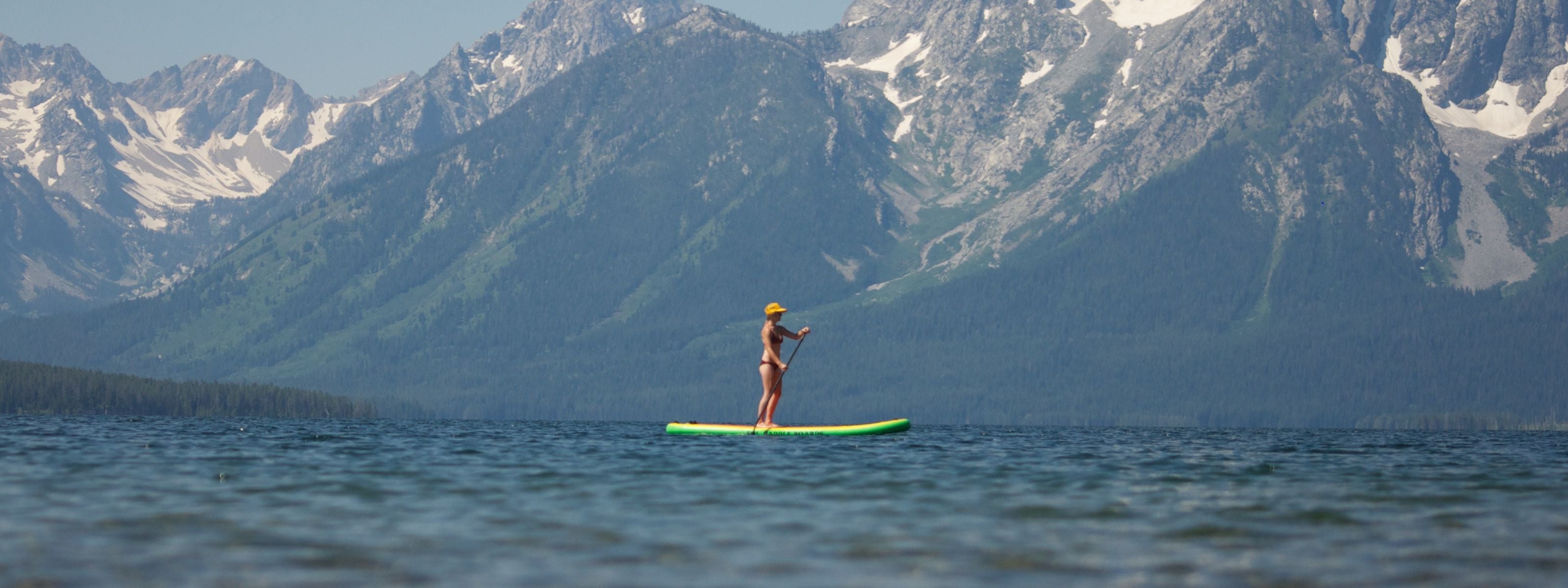 Woman river paddling a SOL Paddle Boards Classic SOLtrain