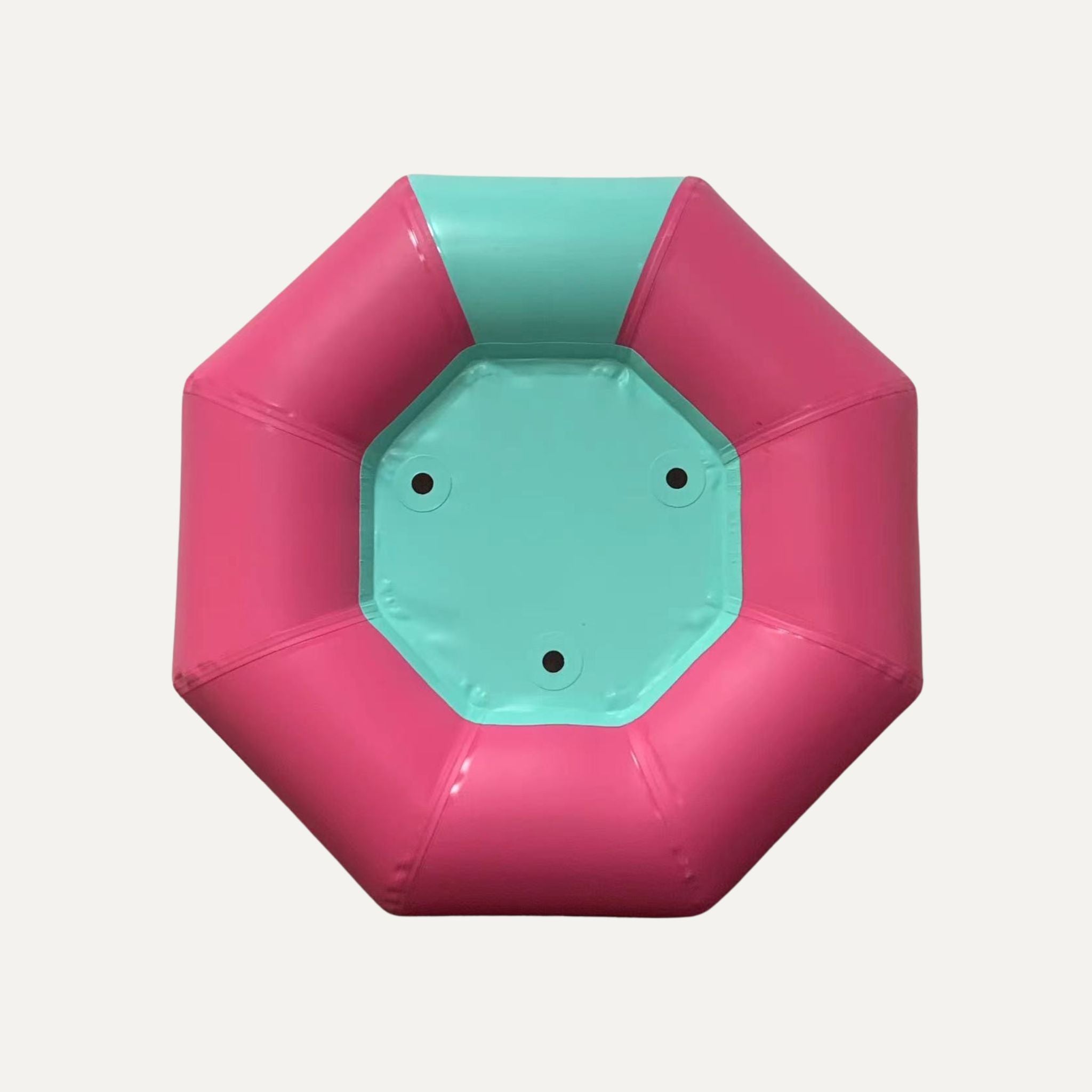 Single SOLtube inflatable in pink and teal, viewed from the bottom.